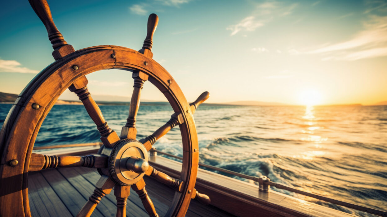 image of helm of a boat in sunset