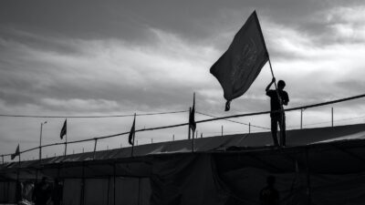 photography of unknown person carrying flag