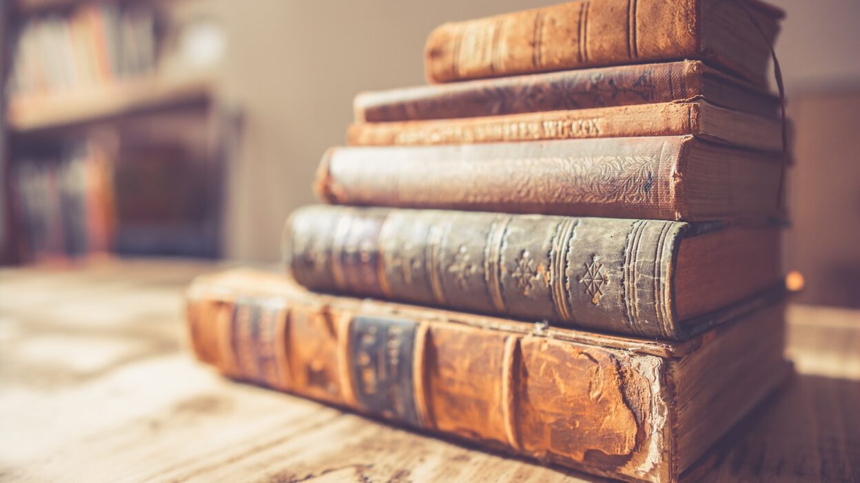 stack of six brown hardbound books