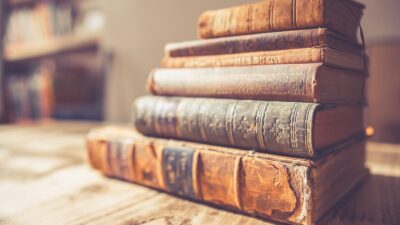 stack of six brown hardbound books