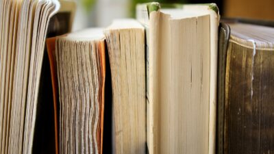 macro photo of five assorted books