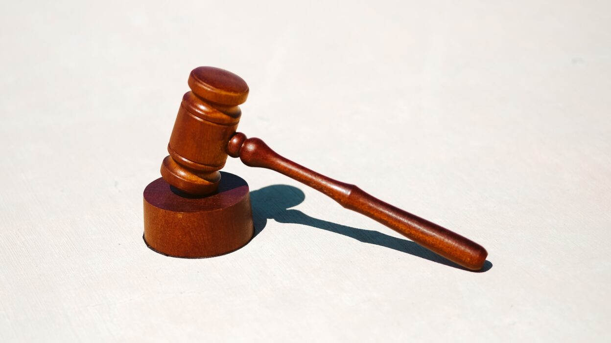 brown wooden gavel on white surface