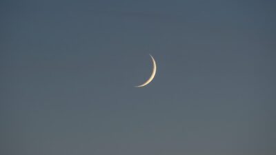 white crescent moon in the sky