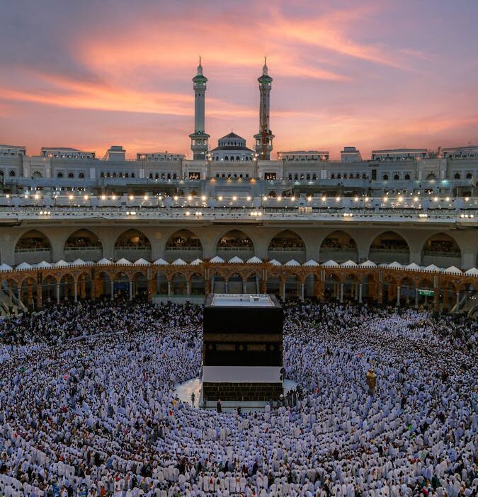 Aerial view of the Kaaba surrounded by worshippers during dusk at the Grand Mosque in Mecca, Saudi Arabia.